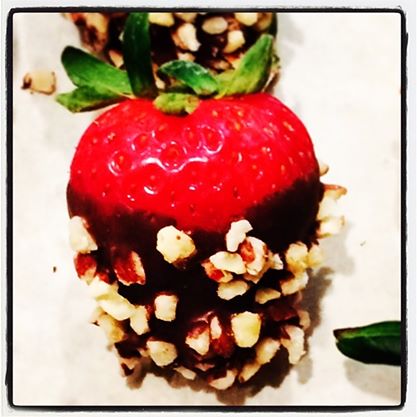 Chocolate covered strawberry rolled in toasted pecans