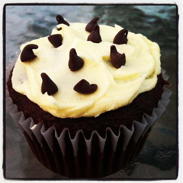 Devil's food cupcake with banana buttercream chocolate chip topped with mini chips