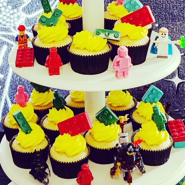 Lego party cake and cupcakes in banana with banana buttercream topped with chocolate Legos